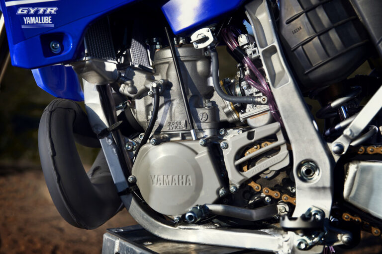 Close-up of a Yamaha motorcycle engine with visible branded parts. The image highlights the mechanical design and components.